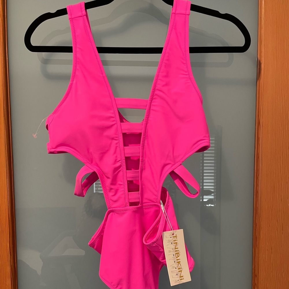 Hot pink. Tags still on. Swimsuit one piece.